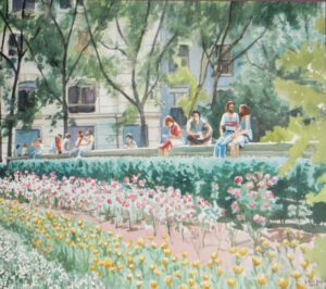 People relax in a park with flowers.
