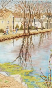 People walking along tree-lined riverbank