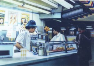 Three people at a diner counter.