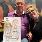 Couple holding a caricature of themselves.